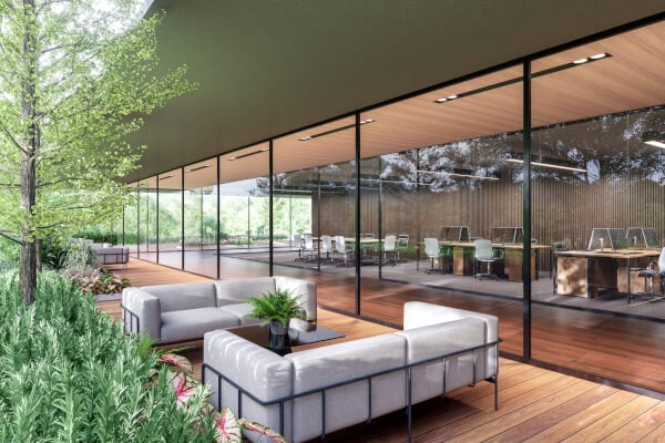 Outside sitting area by office building lined by greenery