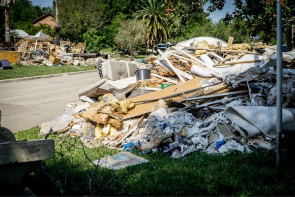 Large pile of destroyed property in the parkway of a home