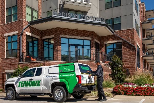 pest tech truck in front of building