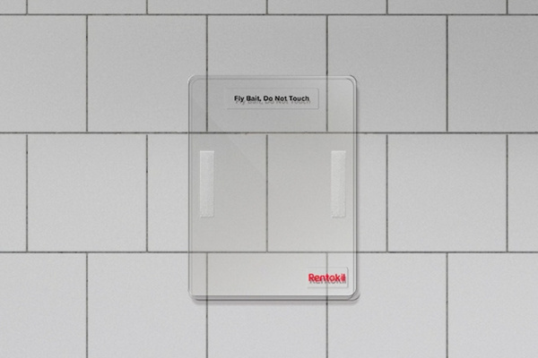 Fly bait station mounted on a white tiled wall