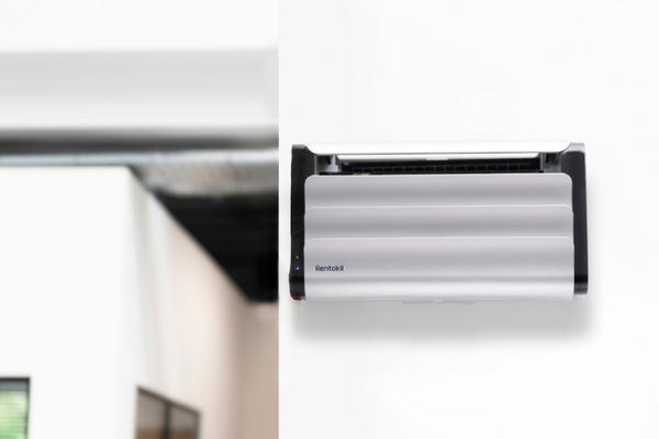 Wall-mounted insect light trap on a white interior wall