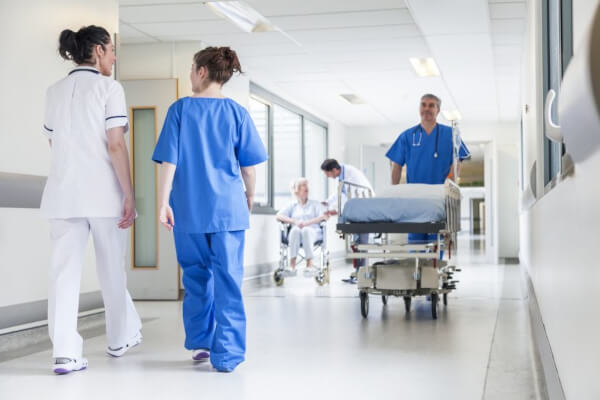 Healthcare workers in hospital hallway