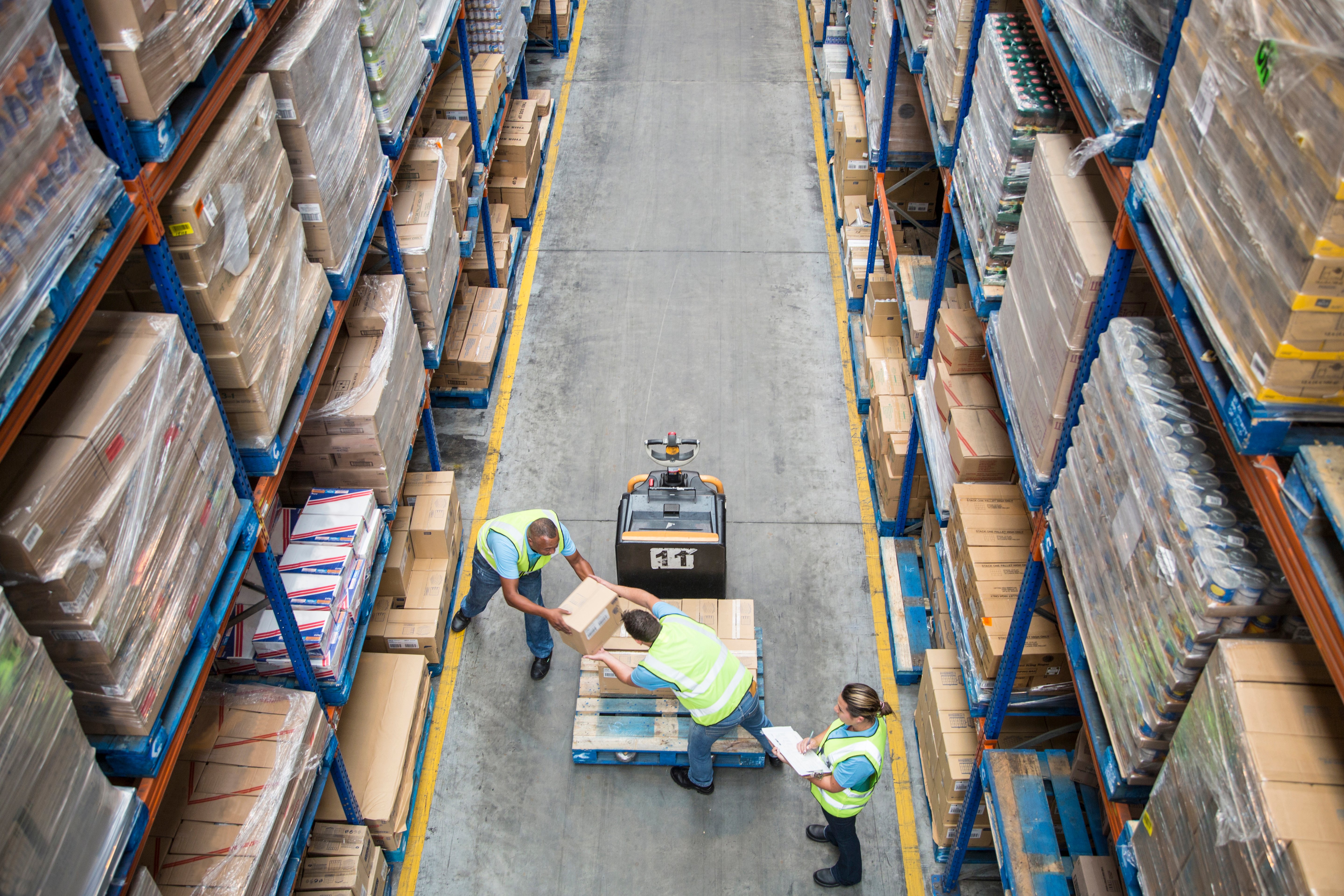 people moving boxes at warehouse