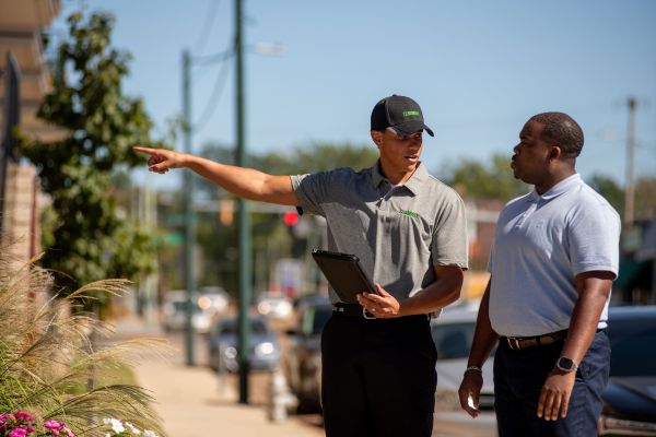 tech pointing outside apt complex