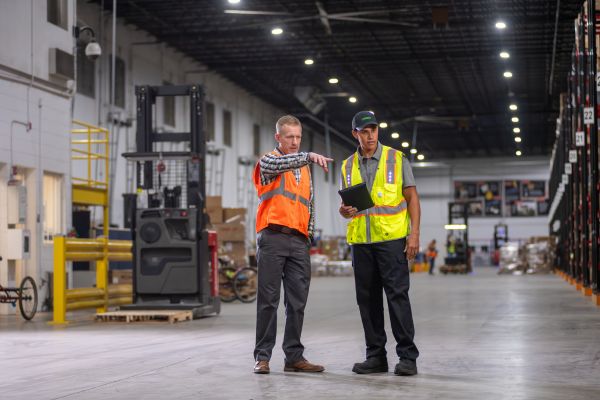 Terminix colleague with customer in a warehouse
