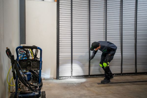technician inspecting under shutter