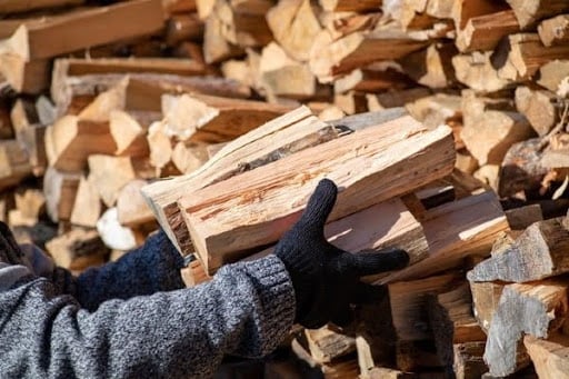Firewood being held by technician